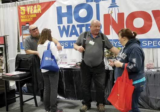 Keith Bohall (right) and Dale Sacry of Hot Water Now, a commercial and residential plumbing contractor, introduce Faster Hot Water’s hot water circulation systems for tankless water heaters at the 2018 Colorado Home Show in Denver.